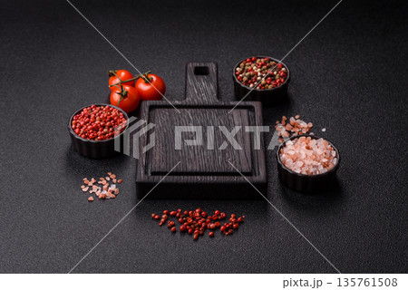 Wood, a wooden empty cutting board on a dark kitchen table. Wooden cutting board Wood, a wooden empty cutting board on a dark kitchen table. Wooden cutting board 135761508
