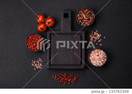 Wood, a wooden empty cutting board on a dark kitchen table. Wooden cutting board Wood, a wooden empty cutting board on a dark kitchen table. Wooden cutting board 135761509