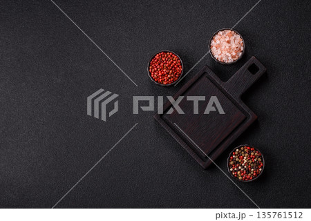 Wood, a wooden empty cutting board on a dark kitchen table. Wooden cutting board Wood, a wooden empty cutting board on a dark kitchen table. Wooden cutting board 135761512