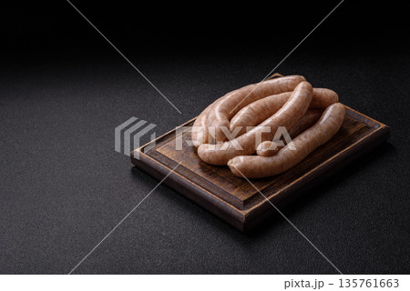 Raw pork or chicken meat sausages for grilling, a spicy picnic food. Raw sausages 135761663