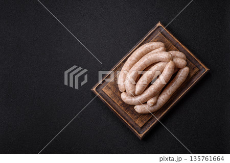 Raw pork or chicken meat sausages for grilling, a spicy picnic food. Raw sausages 135761664