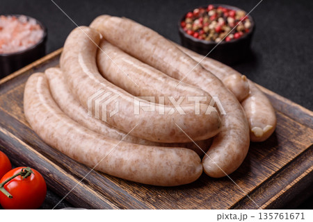 Raw pork or chicken meat sausages for grilling, a spicy picnic food. Raw sausages Raw pork or chicken meat sausages for grilling, a spicy picnic food. Raw sausages 135761671