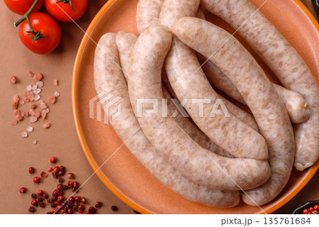 Raw pork or chicken meat sausages for grilling, a spicy picnic food. Raw sausages Raw pork or chicken meat sausages for grilling, a spicy picnic food. Raw sausages 135761684