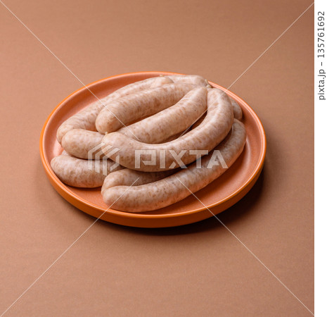 Raw pork or chicken meat sausages for grilling, a spicy picnic food. Raw sausages Raw pork or chicken meat sausages for grilling, a spicy picnic food. Raw sausages 135761692