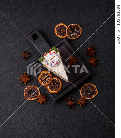 A slice of sweet layered cake with a Christmas ornament and fruit flavor. A slice of cake A slice of sweet layered cake with a Christmas ornament and fruit flavor. A slice of cake 135762084