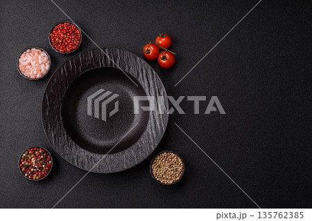 An empty round ceramic plate on a table, kitchenware. An empty plate An empty round ceramic plate on a table, kitchenware. An empty plate 135762385