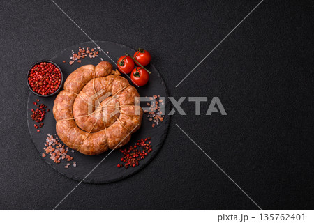 Grilled sausage in the shape of a spiral or snail, from chicken or pork. Spiral or snail sausage 135762401