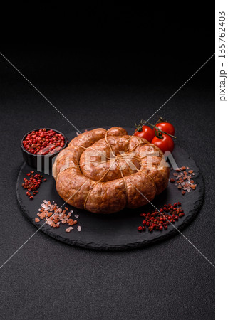 Grilled sausage in the shape of a spiral or snail, from chicken or pork. Spiral or snail sausage Grilled sausage in the shape of a spiral or snail, from chicken or pork. Spiral or snail sausage 135762403