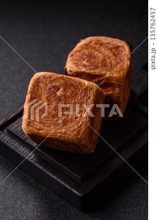 A French cube croissant with chocolate filling, a sweet breakfast pastry. Cube croissant A French cube croissant with chocolate filling, a sweet breakfast pastry. Cube croissant 135762457