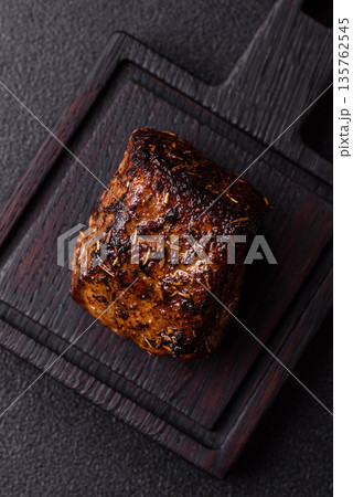Grilled or barbecued beef steak, a fillet of meat cooked for dinner. Beef steak 135762545