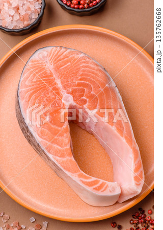 Fish, raw salmon steak, fresh seafood for grilling with salt, spices, and herbs. Raw salmon steak 135762668