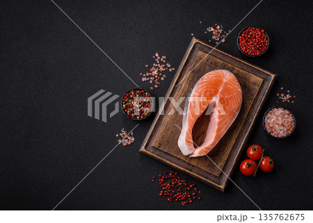 Fish, raw salmon steak, fresh seafood for grilling with salt, spices, and herbs. Raw salmon steak 135762675