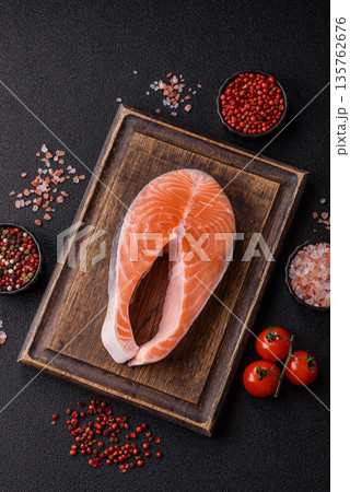 Fish, raw salmon steak, fresh seafood for grilling with salt, spices, and herbs. Raw salmon steak Fish, raw salmon steak, fresh seafood for grilling with salt, spices, and herbs. Raw salmon steak 135762676