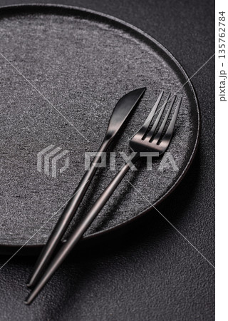 An empty round ceramic plate on a table, kitchenware. An empty plate 135762784