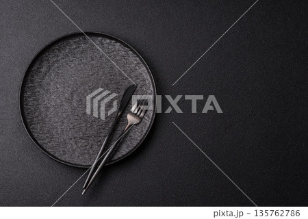 An empty round ceramic plate on a table, kitchenware. An empty plate 135762786