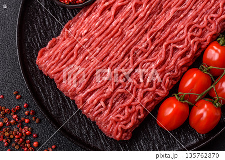 Raw ground beef or pork for burgers or meatballs with salt and spices. Raw ground beef Raw ground beef or pork for burgers or meatballs with salt and spices. Raw ground beef 135762870