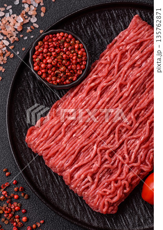 Raw ground beef or pork for burgers or meatballs with salt and spices. Raw ground beef Raw ground beef or pork for burgers or meatballs with salt and spices. Raw ground beef 135762871