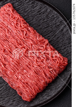 Raw ground beef or pork for burgers or meatballs with salt and spices. Raw ground beef Raw ground beef or pork for burgers or meatballs with salt and spices. Raw ground beef 135762874