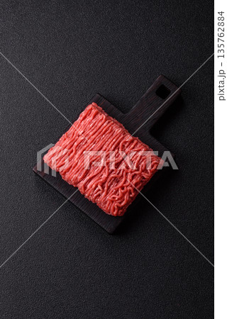 Raw ground beef or pork for burgers or meatballs with salt and spices. Raw ground beef Raw ground beef or pork for burgers or meatballs with salt and spices. Raw ground beef 135762884
