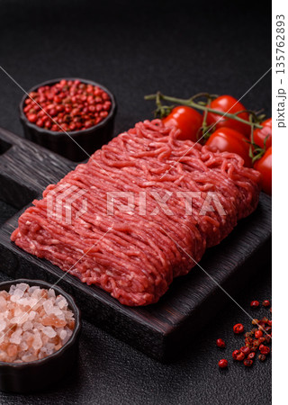 Raw ground beef or pork for burgers or meatballs with salt and spices. Raw ground beef Raw ground beef or pork for burgers or meatballs with salt and spices. Raw ground beef 135762893