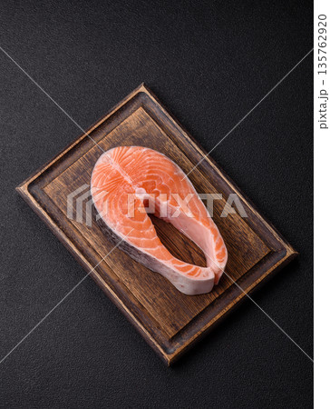 Fish, raw salmon steak, fresh seafood for grilling with salt, spices, and herbs. Raw salmon steak Fish, raw salmon steak, fresh seafood for grilling with salt, spices, and herbs. Raw salmon steak 135762920