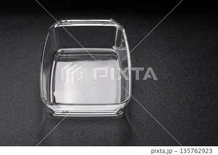 A rectangular transparent glass tray for baking and cooking at home. The glass tray A rectangular transparent glass tray for baking and cooking at home. The glass tray 135762923