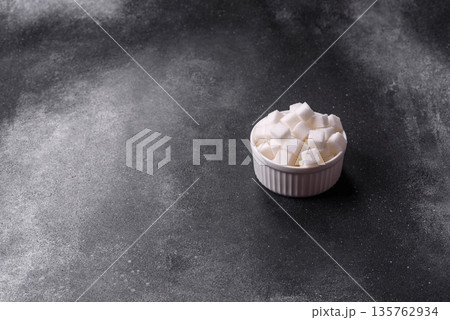 Sweet white sugar cubes as a source of glucose. White sugar cubes as a food background Sweet white sugar cubes as a source of glucose. White sugar cubes as a food background 135762934