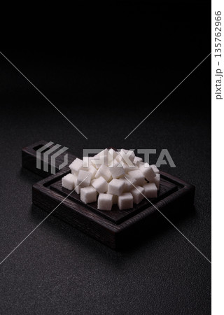 Sweet white sugar cubes as a source of glucose. White sugar cubes as a food background 135762966