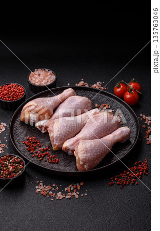 Chicken meat, raw drumsticks on the bone for grilling with salt and spices. Raw chicken drumsticks Chicken meat, raw drumsticks on the bone for grilling with salt and spices. Raw chicken drumsticks 135763046