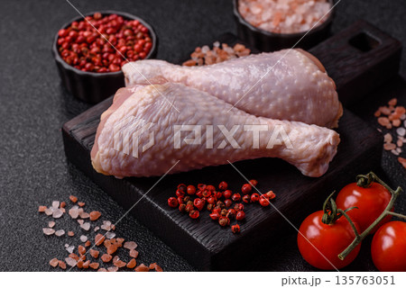Chicken meat, raw drumsticks on the bone for grilling with salt and spices. Raw chicken drumsticks 135763051