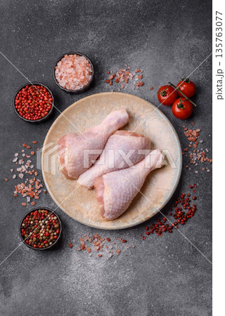Chicken meat, raw drumsticks on the bone for grilling with salt and spices. Raw chicken drumsticks Chicken meat, raw drumsticks on the bone for grilling with salt and spices. Raw chicken drumsticks 135763077