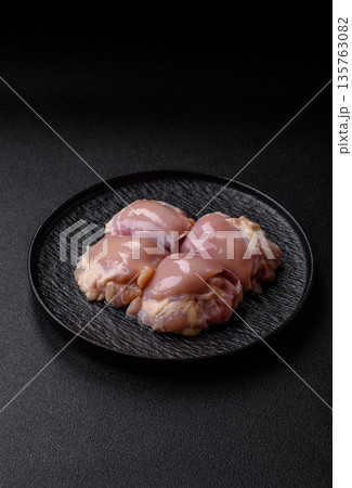Chicken meat, raw boneless thigh fillets for grilling with salt. Raw chicken thigh fillets Chicken meat, raw boneless thigh fillets for grilling with salt. Raw chicken thigh fillets 135763082