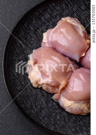 Chicken meat, raw boneless thigh fillets for grilling with salt. Raw chicken thigh fillets Chicken meat, raw boneless thigh fillets for grilling with salt. Raw chicken thigh fillets 135763085