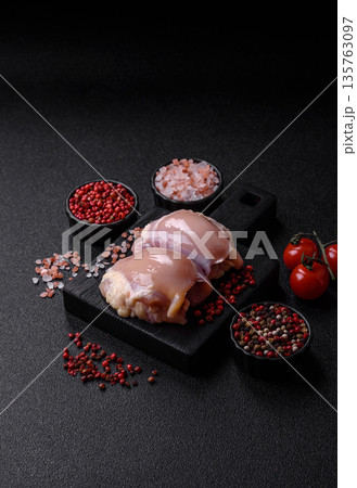 Chicken meat, raw boneless thigh fillets for grilling with salt. Raw chicken thigh fillets Chicken meat, raw boneless thigh fillets for grilling with salt. Raw chicken thigh fillets 135763097