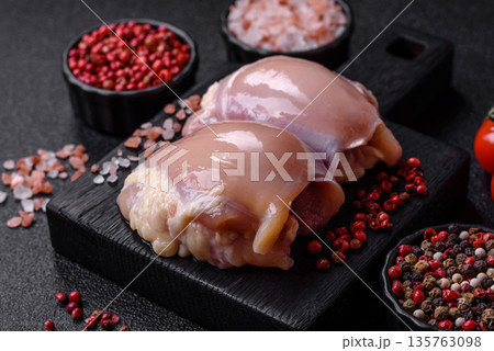 Chicken meat, raw boneless thigh fillets for grilling with salt. Raw chicken thigh fillets 135763098