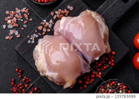 Chicken meat, raw boneless thigh fillets for grilling with salt. Raw chicken thigh fillets Chicken meat, raw boneless thigh fillets for grilling with salt. Raw chicken thigh fillets 135763099
