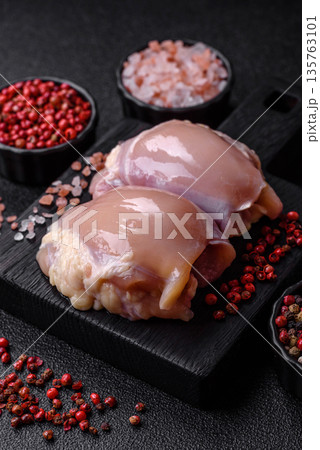Chicken meat, raw boneless thigh fillets for grilling with salt. Raw chicken thigh fillets Chicken meat, raw boneless thigh fillets for grilling with salt. Raw chicken thigh fillets 135763101