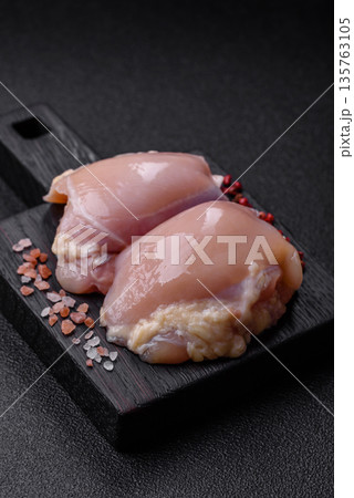 Chicken meat, raw boneless thigh fillets for grilling with salt. Raw chicken thigh fillets Chicken meat, raw boneless thigh fillets for grilling with salt. Raw chicken thigh fillets 135763105
