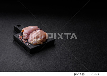 Chicken meat, raw boneless thigh fillets for grilling with salt. Raw chicken thigh fillets Chicken meat, raw boneless thigh fillets for grilling with salt. Raw chicken thigh fillets 135763106
