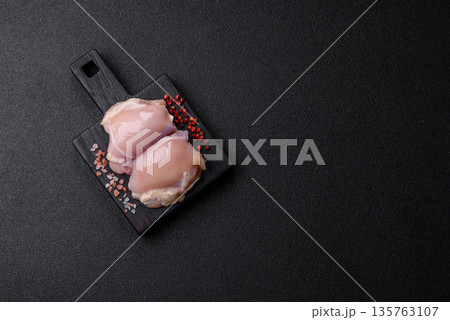 Chicken meat, raw boneless thigh fillets for grilling with salt. Raw chicken thigh fillets Chicken meat, raw boneless thigh fillets for grilling with salt. Raw chicken thigh fillets 135763107