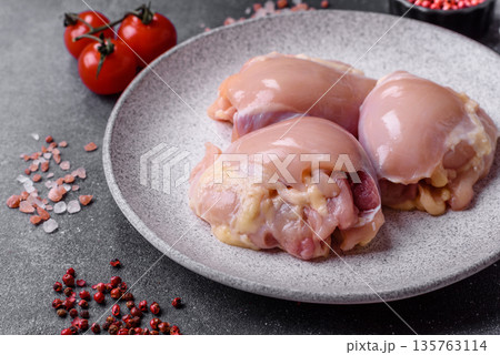 Chicken meat, raw boneless thigh fillets for grilling with salt. Raw chicken thigh fillets 135763114