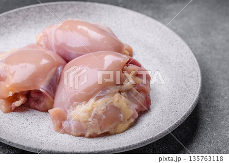 Chicken meat, raw boneless thigh fillets for grilling with salt. Raw chicken thigh fillets Chicken meat, raw boneless thigh fillets for grilling with salt. Raw chicken thigh fillets 135763118