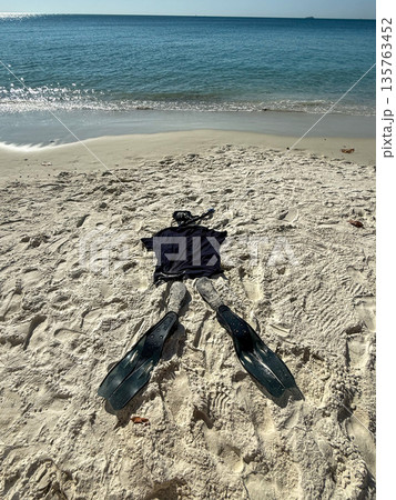 Snorkeling Gear Laid Out on Sandy Beach Near Ocean Snorkeling Gear Laid Out on Sandy Beach Near Ocean 135763452