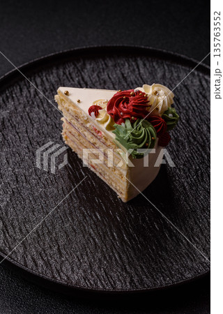 A slice of sweet layered cake with white cream for a birthday or holiday. A slice of cake A slice of sweet layered cake with white cream for a birthday or holiday. A slice of cake 135763552