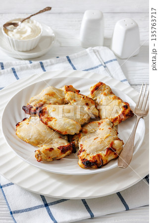 Baked boneless chicken thighs and yogurt dip bowl Baked boneless chicken thighs and yogurt dip bowl 135763717