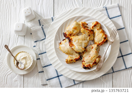 Baked boneless chicken thighs and yogurt dip bowl Baked boneless chicken thighs and yogurt dip bowl 135763721