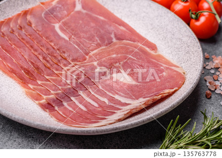 Meat, ham, jamon, or prosciutto sliced for breakfast bruschetta. Sliced ham, jamon, or prosciutto Meat, ham, jamon, or prosciutto sliced for breakfast bruschetta. Sliced ham, jamon, or prosciutto 135763778
