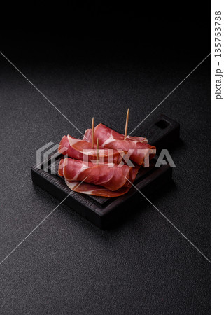 Meat, ham, jamon, or prosciutto sliced for breakfast bruschetta. Sliced ham, jamon, or prosciutto 135763788