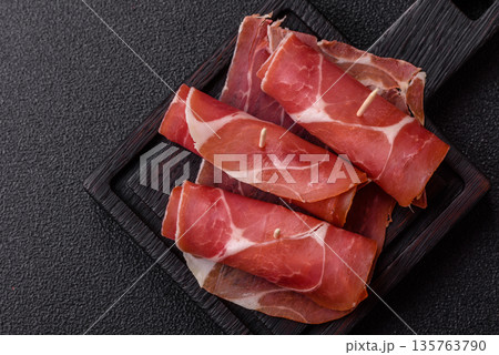 Meat, ham, jamon, or prosciutto sliced for breakfast bruschetta. Sliced ham, jamon, or prosciutto Meat, ham, jamon, or prosciutto sliced for breakfast bruschetta. Sliced ham, jamon, or prosciutto 135763790