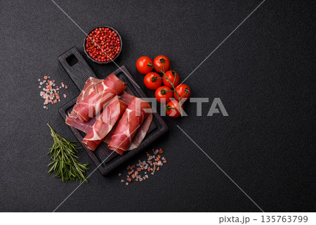 Meat, ham, jamon, or prosciutto sliced for breakfast bruschetta. Sliced ham, jamon, or prosciutto 135763799